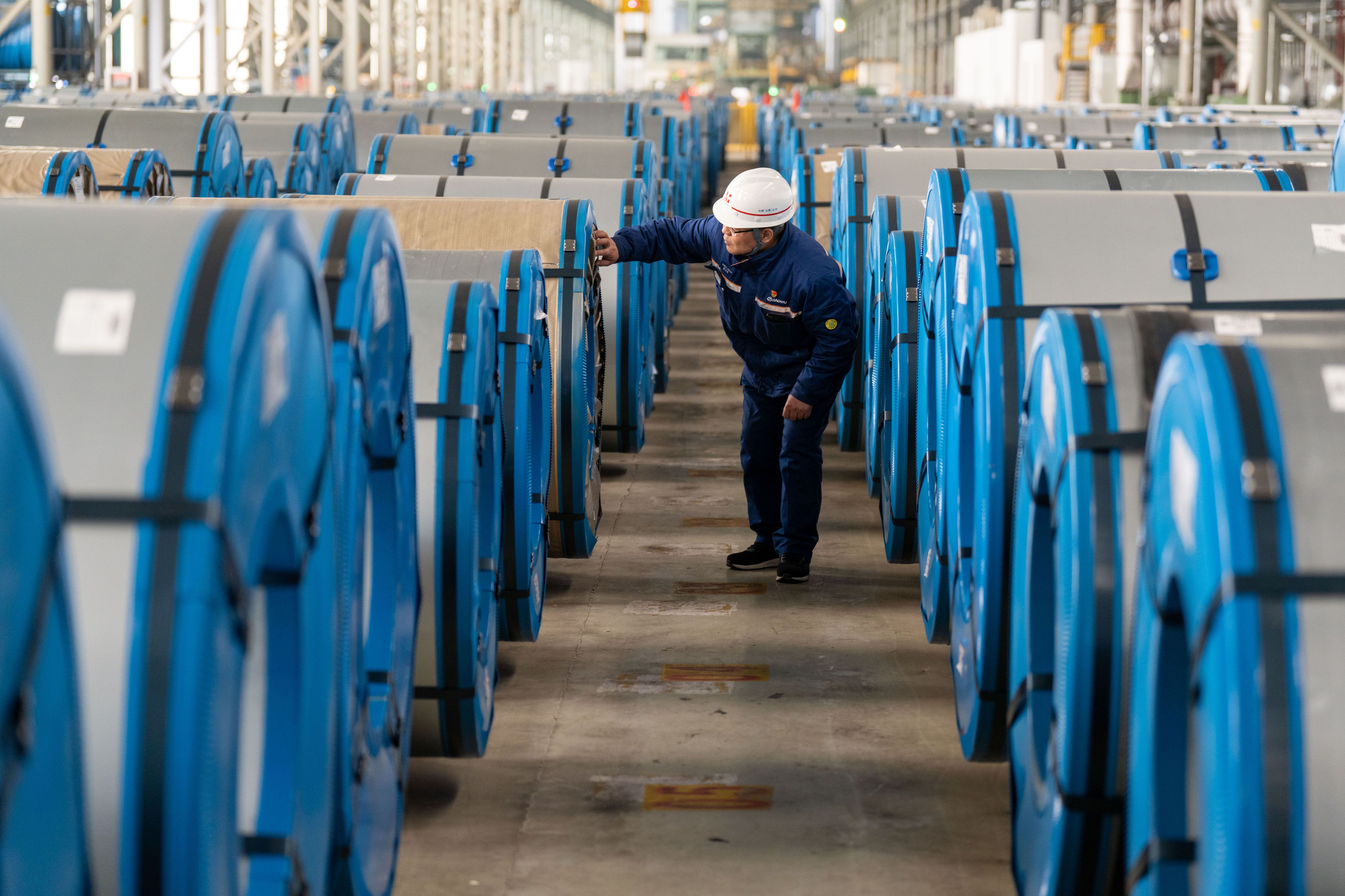 A worker delivering steel coils at the in Hefei, China. 