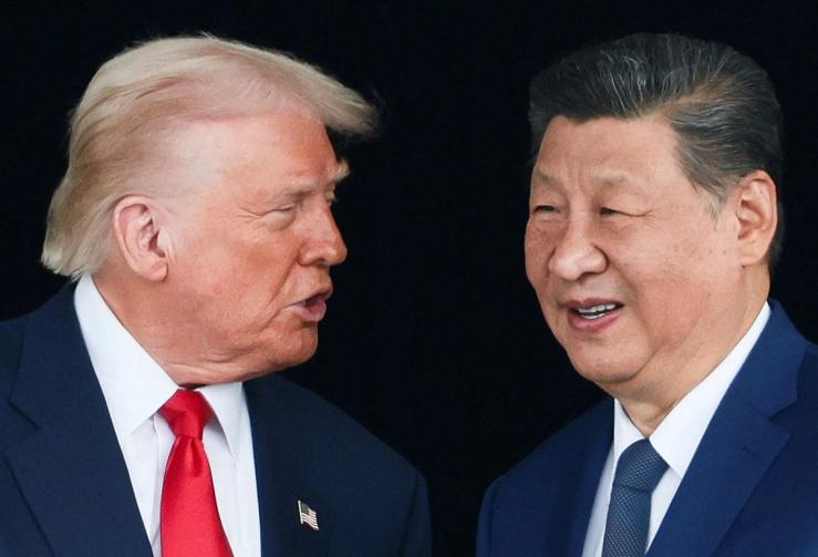 U.S. President Donald Trump and Chinese President Xi Jinping talk as they leave after a bilateral meeting at Gimhae International Airport, on the sidelines of the Asia-Pacific Economic Cooperation (APEC) summit, in Busan, South Korea