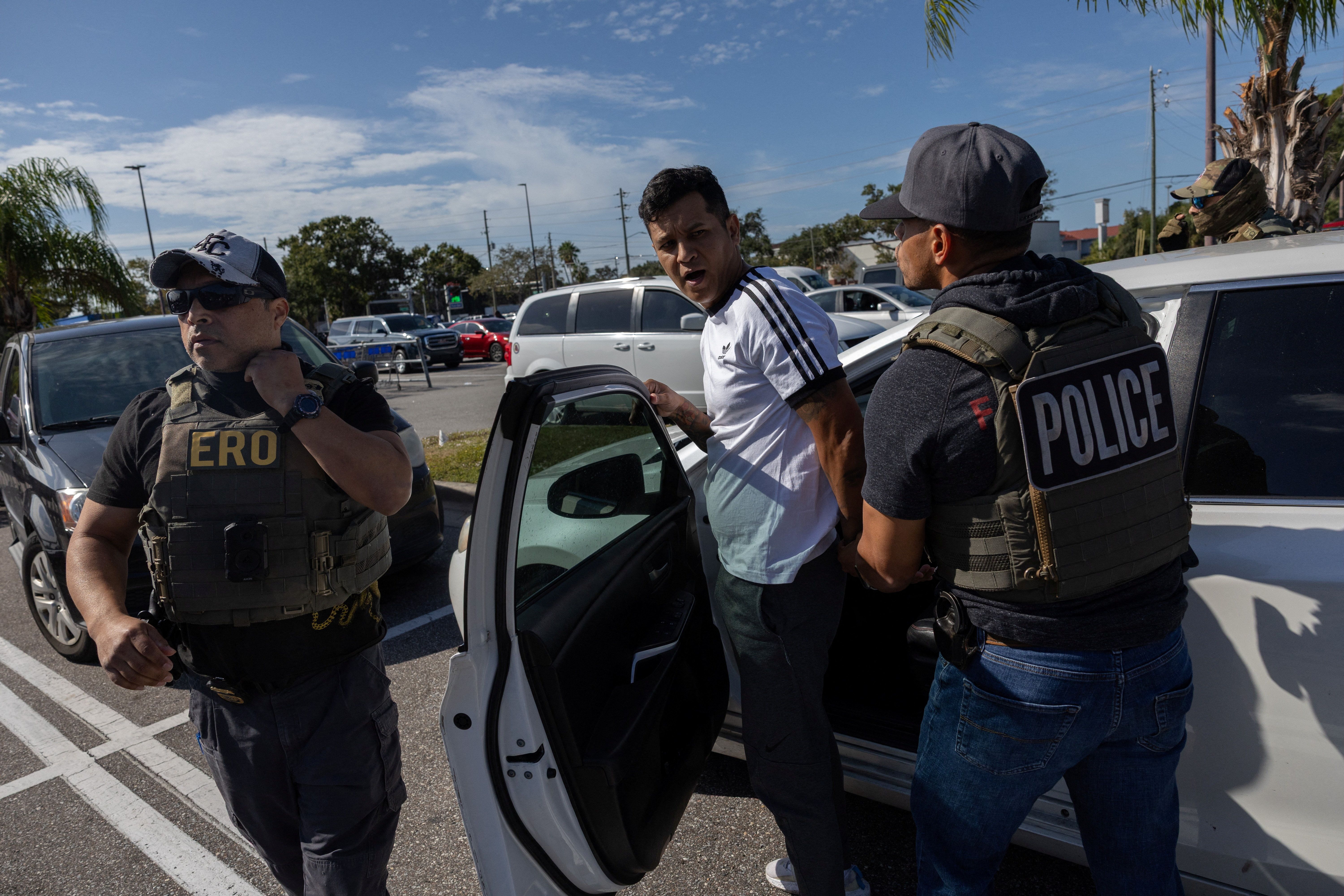 Federal agents arrest a man in an immigration enforcement operation.