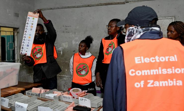 An election official displays a ballot paper during the counting of votes after the polls closed in Lusaka, Zambia.