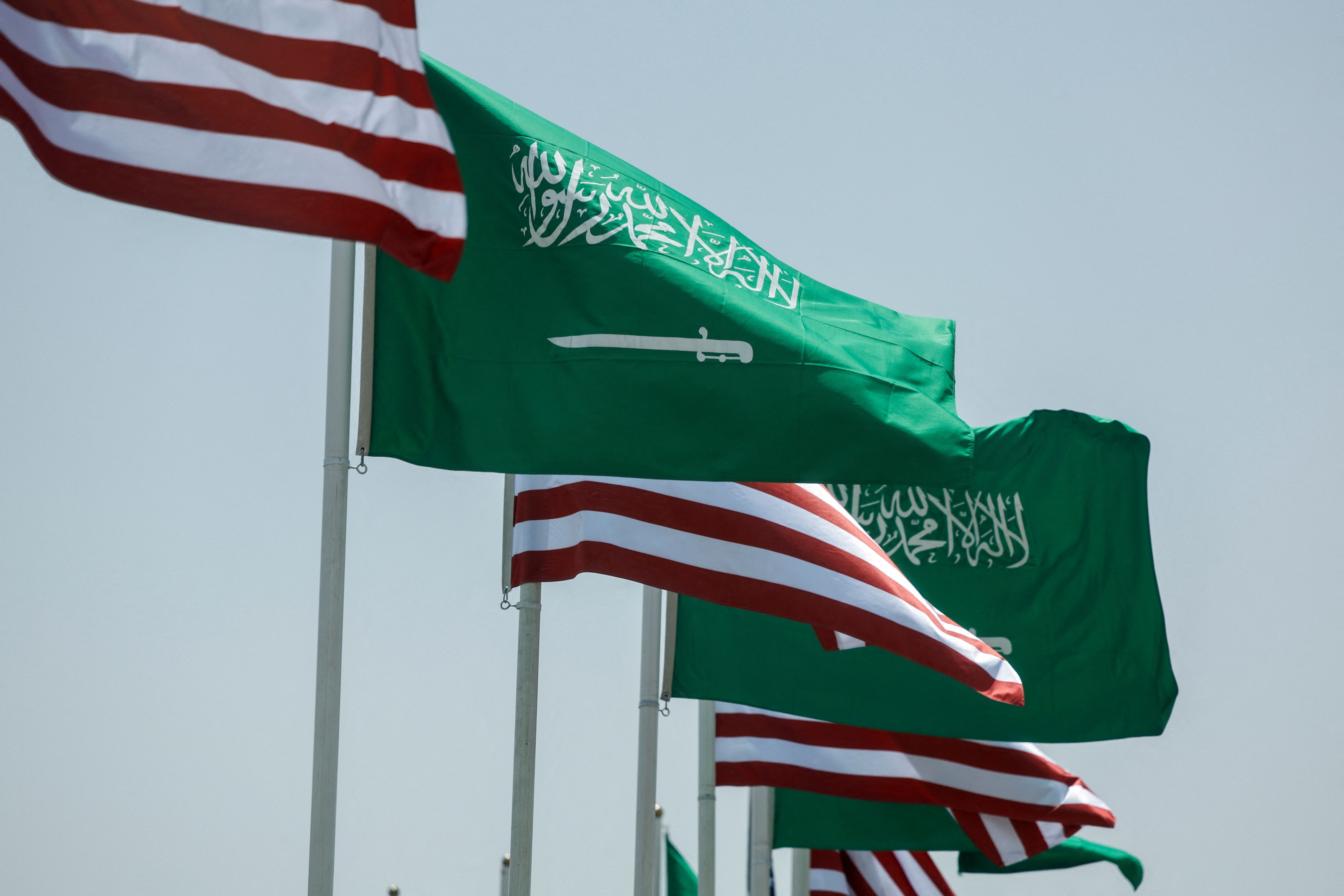U.S. and Saudi flags flutter along a highway of Riyadh, as pictured through the glass of a car, ahead of the arrival of U.S. President Donald Trump to Riyadh, Saudi Arabia May 12, 2025.
