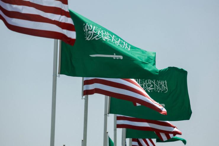 U.S. and Saudi flags flutter along a highway of Riyadh, as pictured through the glass of a car, ahead of the arrival of U.S. President Donald Trump to Riyadh, Saudi Arabia May 12, 2025.