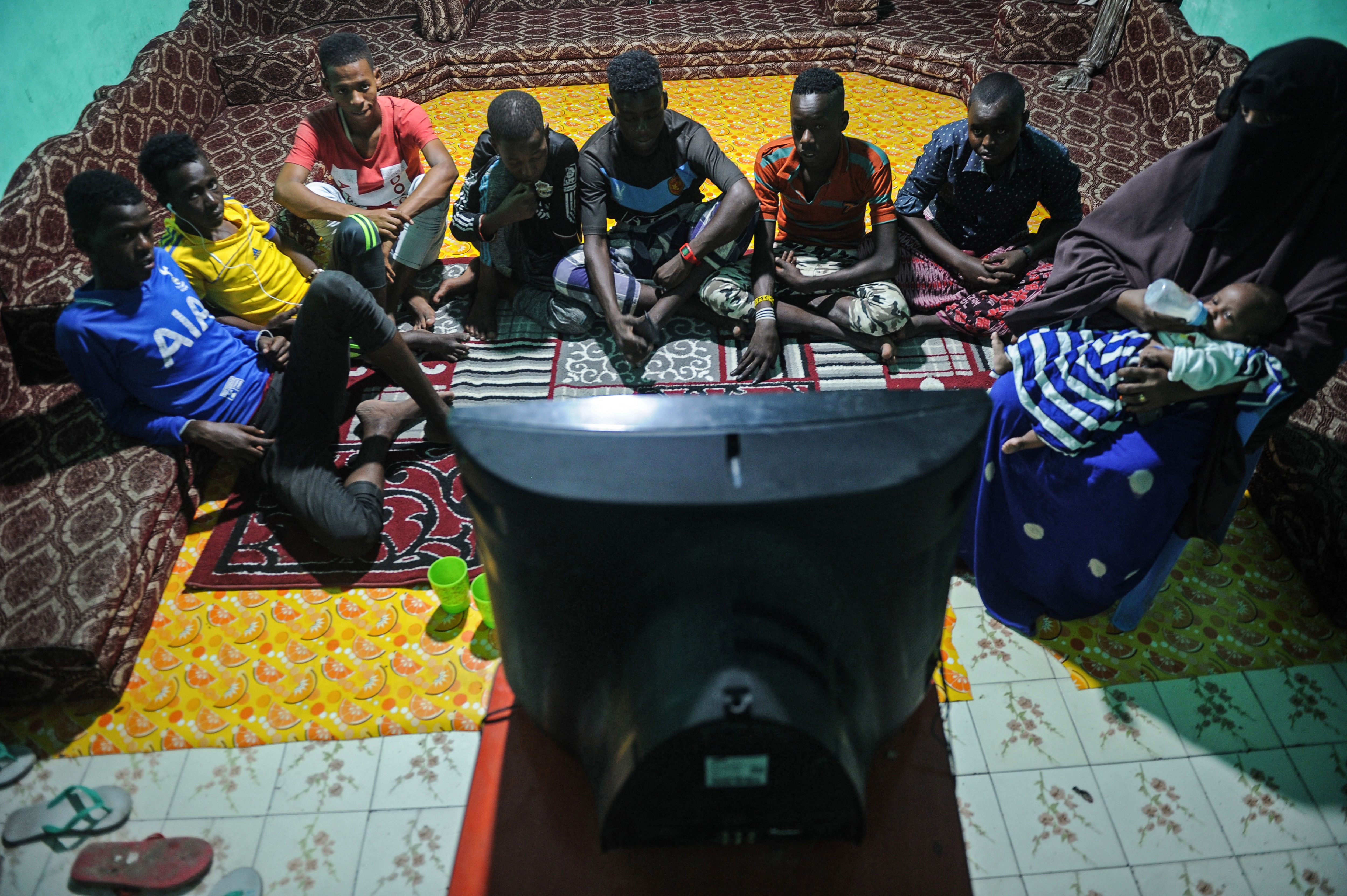 A group watches TV in Somalia.