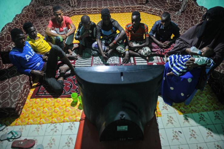 A group watches TV in Somalia.