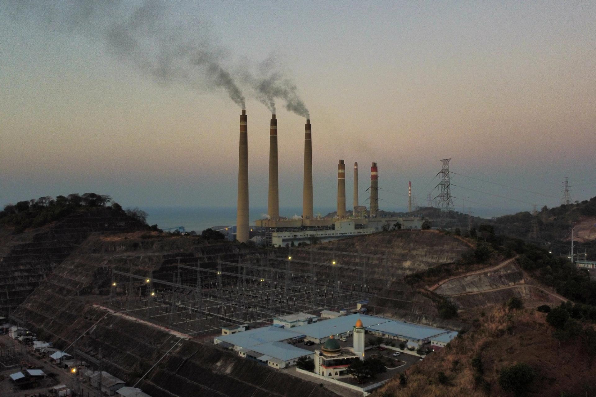 Smoke ash spews from the chimney of a coal power plant owned by Indonesian Power