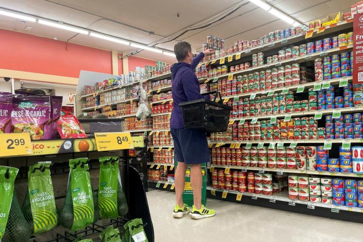 A person shops in an Albertsons supermarket