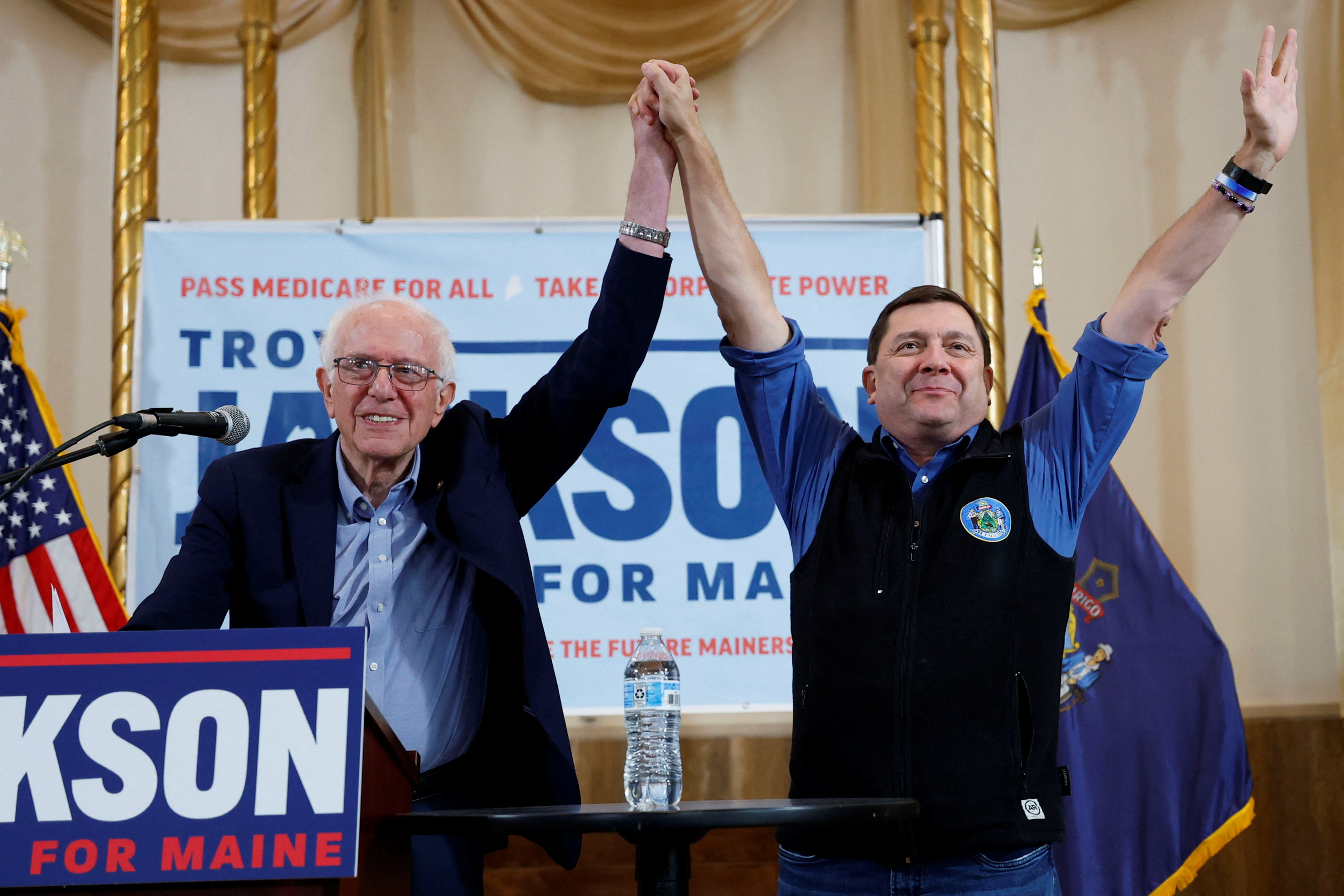 Democratic candidate for the US Senate in Maine Troy Jackson gestures to the audience with Senator Bernie Sanders