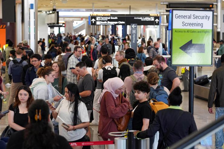 Passengers wait in long TSA lines as a partial government shutdown continues, at Hartsfield-Jackson Atlanta International Airport