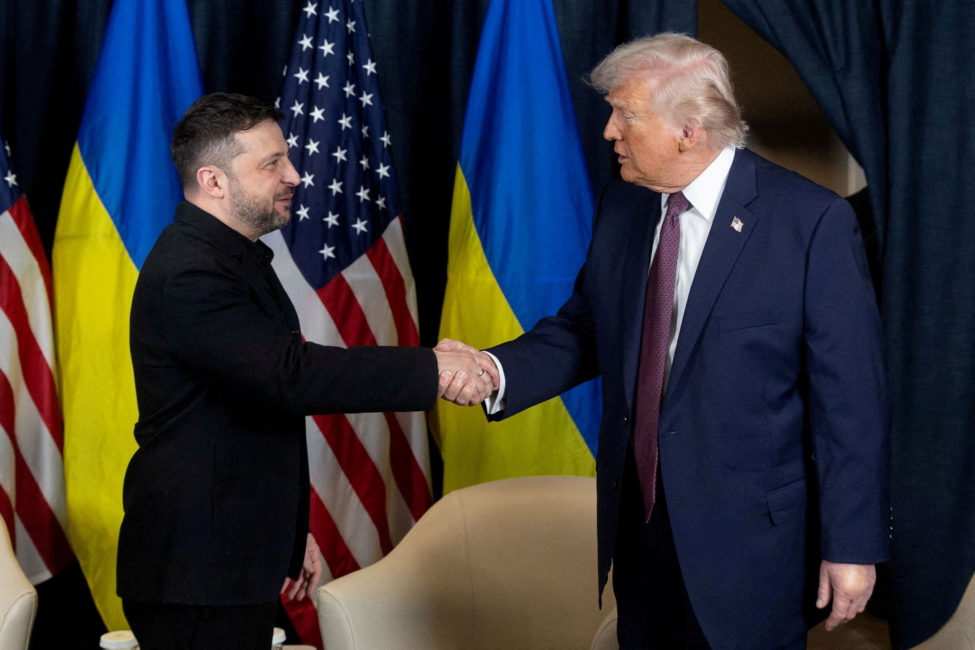 Ukrainian President Volodymyr Zelenskiy and U.S. President Donald Trump shake hands.