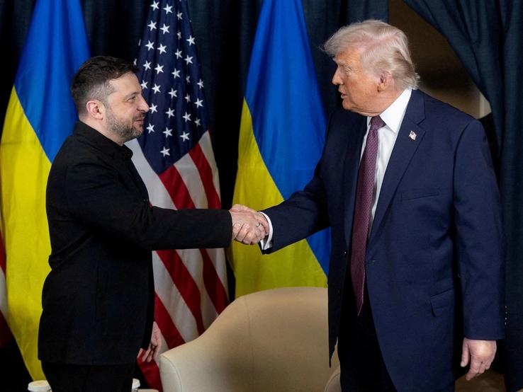 Ukrainian President Volodymyr Zelenskiy and U.S. President Donald Trump shake hands.