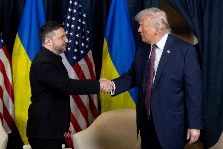 Ukrainian President Volodymyr Zelenskiy and U.S. President Donald Trump shake hands.