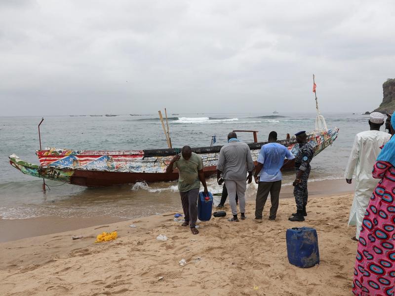Locals remove fuel containers from the boat that ran aground off the coast of Ouakam, carrying migrants who attempted irregular immigration, Dakar, Senegal, July 24, 2023. REUTERS/Ngouda Dione