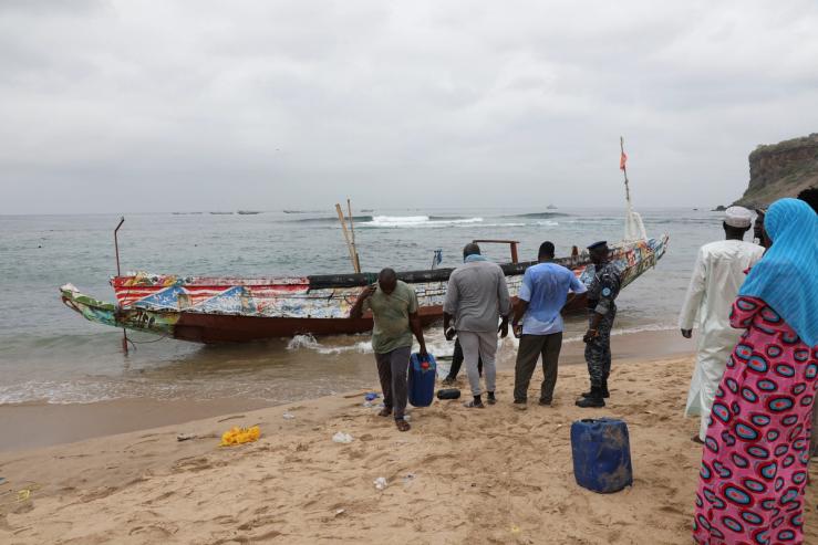 Locals remove fuel containers from the boat that ran aground off the coast of Ouakam, carrying migrants who attempted irregular immigration, Dakar, Senegal, July 24, 2023. REUTERS/Ngouda Dione