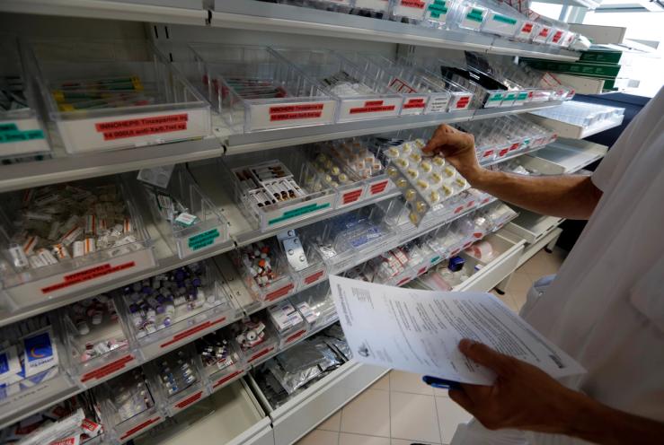A pharmacist selects drugs for chemotherapy treatment in the pharmacy at Antoine-Lacassagne Cancer Centre in Nice.