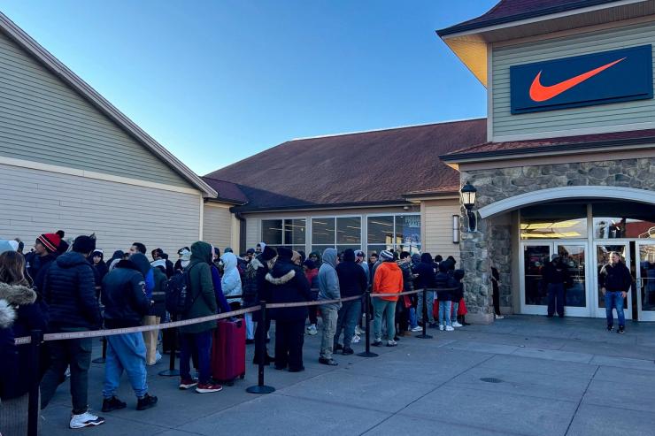People queue up outside of the Nike store.