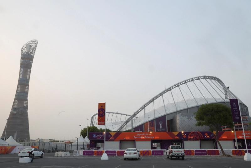 A man rests in front of Aspire Tower at Khalifa International Stadium ahead of the FIFA 2022 World Cup soccer tournament in Doha, Qatar
