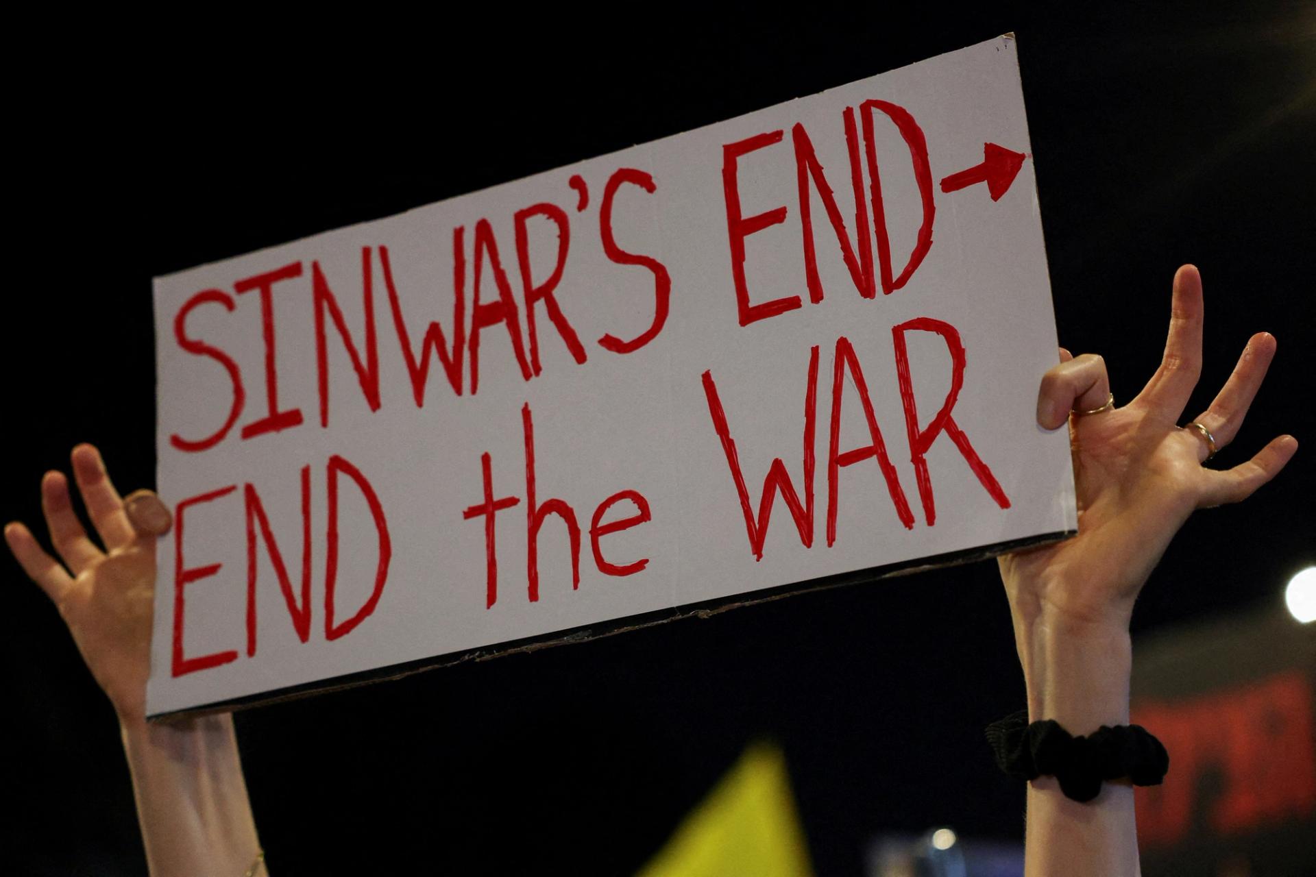 A person holds a sign in Tel Aviv saying "Sinwar's end, end the war."