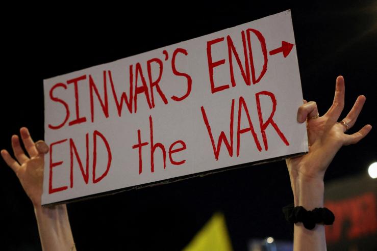 A person holds a sign in Tel Aviv saying “Sinwar’s end, end the war.”