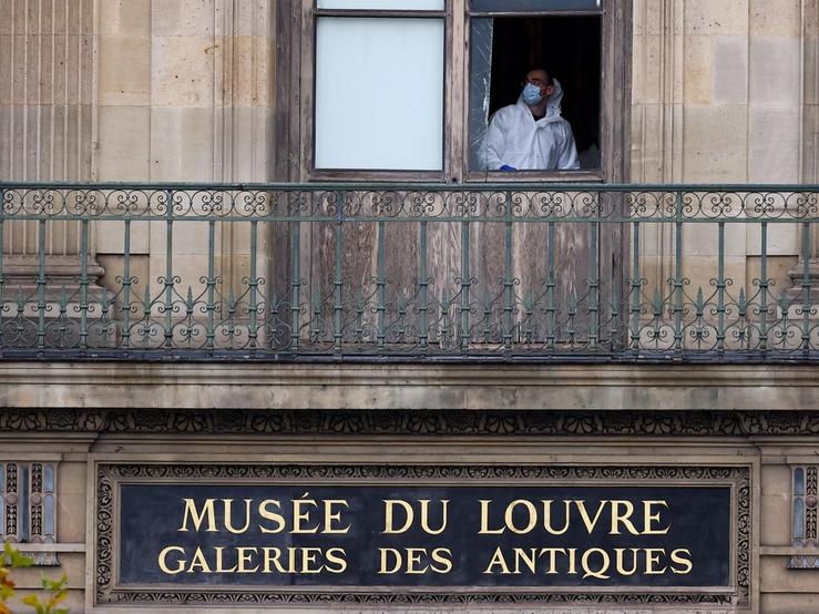 A member of a forensic team inspects a window believed to have been used in what the French Interior Ministry said was a robbery at the Louvre museum during which jewellery was stolen, in Paris, France, October 19, 2025