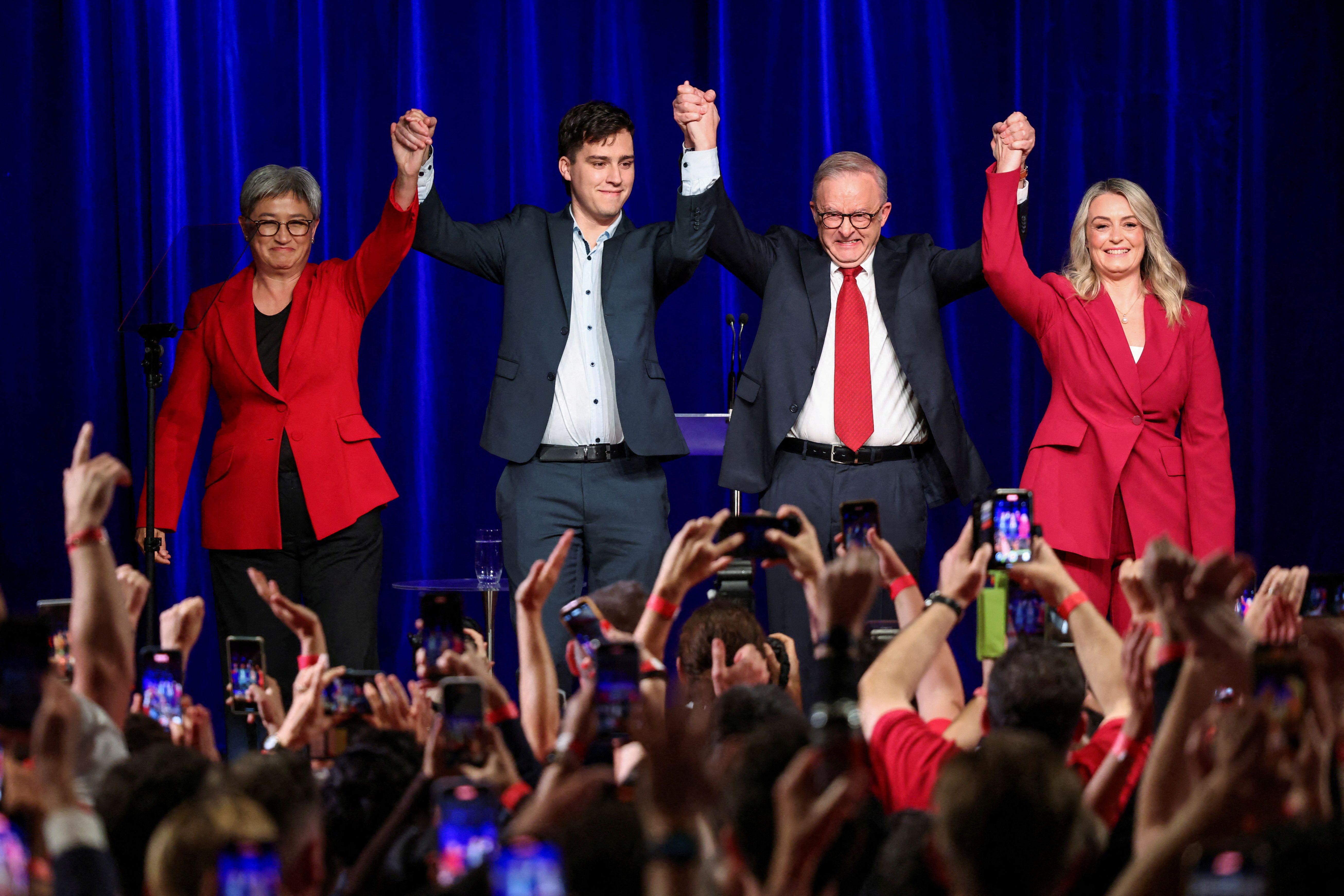 Australia’s Prime Minister Anthony Albanese celebrates with his partner Jodie Haydon, his son Nathan Albanese and Minister for Foreign Affairs Penny Wong at a Labor party election night event