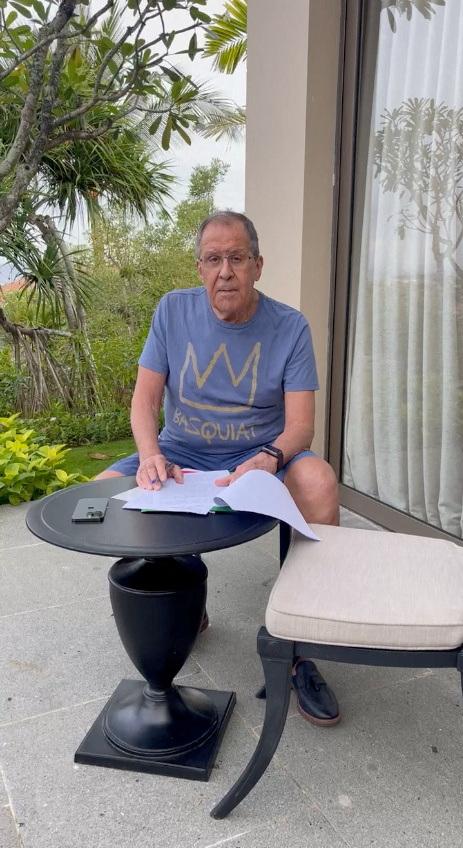 Russian Foreign Minister Sergei Lavrov reads documents on a patio in Bali, Indonesia November 14, 2022, in this still image taken from video uploaded on the Telegram channel of Foreign Ministry Spokeswoman Maria Zakharova.