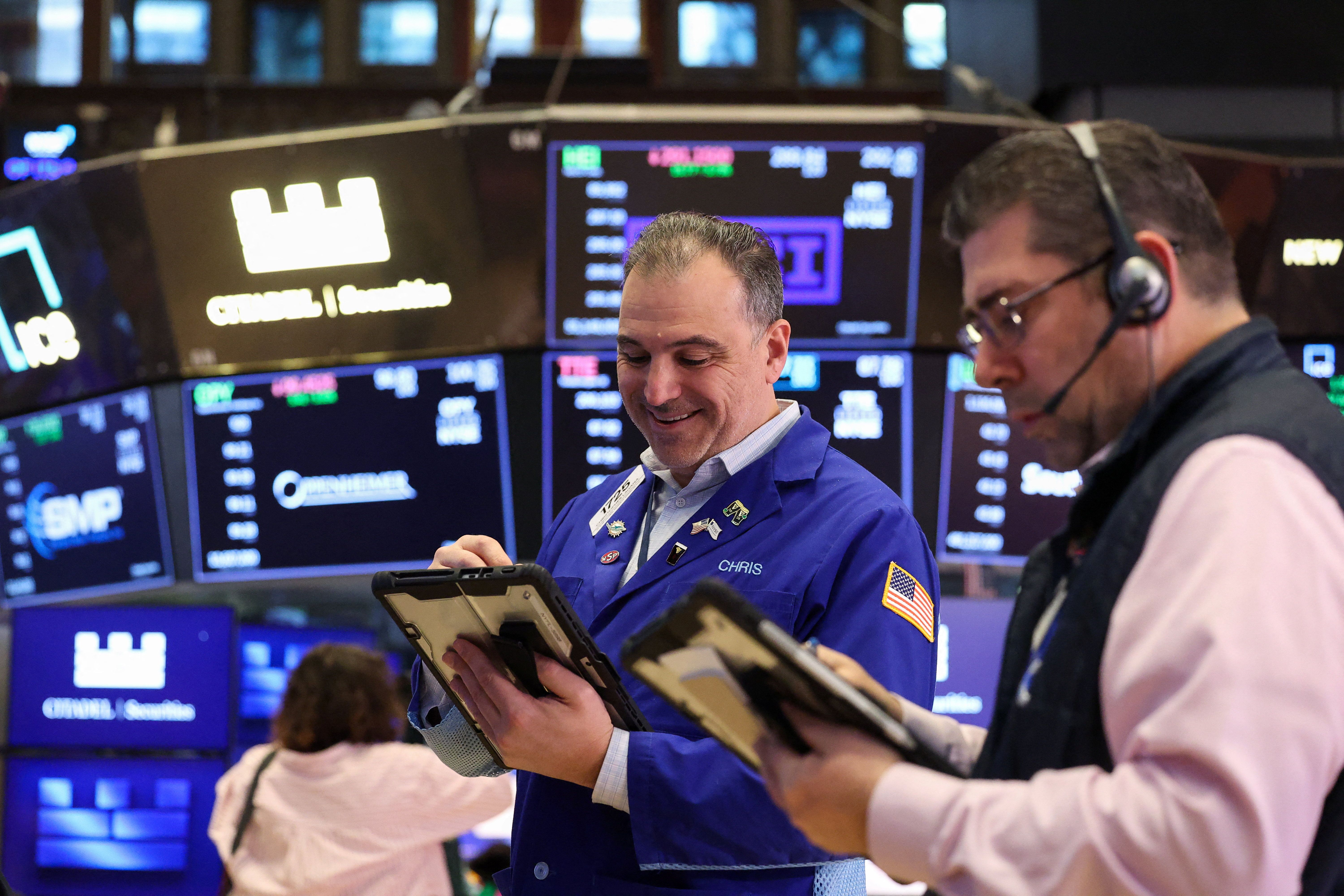 Traders work on the floor at the New York Stock Exchange