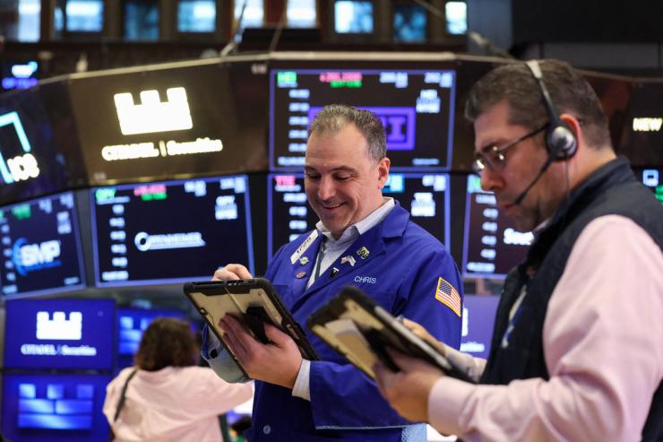 Traders work on the floor at the New York Stock Exchange