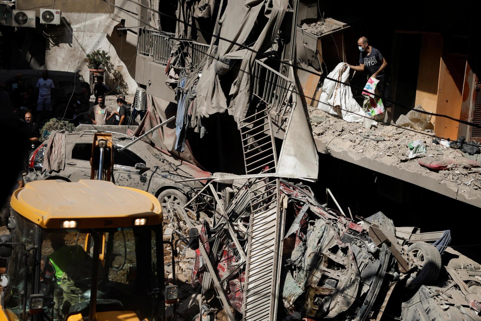 People inspect the wreckage of an Israeli airstrike in Beirut. 