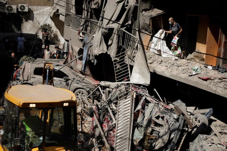 People inspect the wreckage of an Israeli airstrike in Beirut.