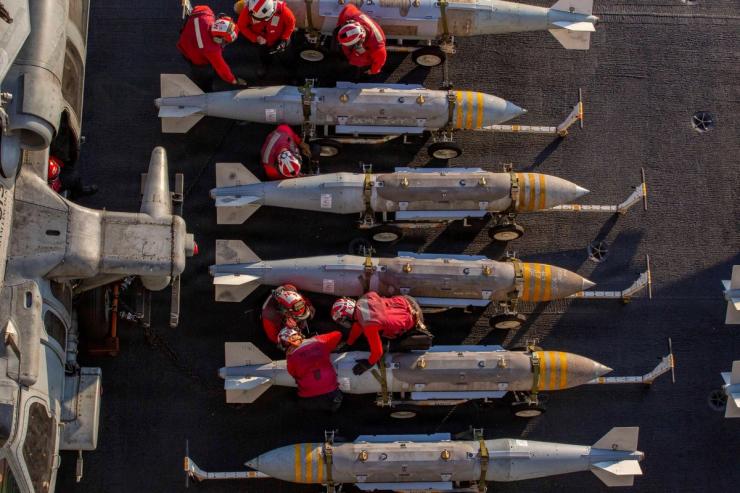 U.S. Navy sailors prepare to stage ordnance on the flight deck of the Nimitz-class aircraft carrier USS Abraham Lincoln in support of the Operation Epic Fury attack on Iran