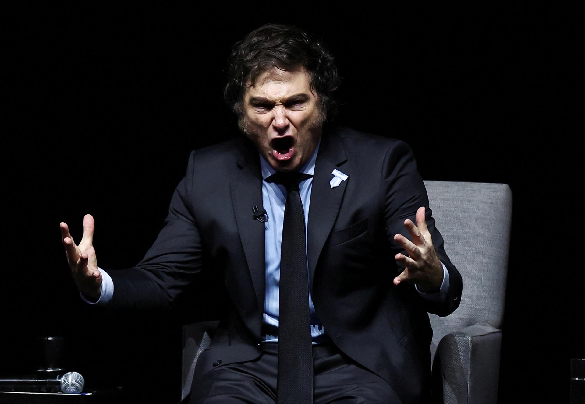 Javier Milei gestures on stage as he presents his new book “Capitalism, Socialism and the Neoclassical Trap”, at the Luna Park stadium, in Buenos Aires