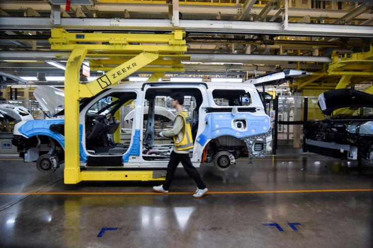 Workers build Zeekr 009 electric minivans at Zeekr’s factory in Ningbo, China.
