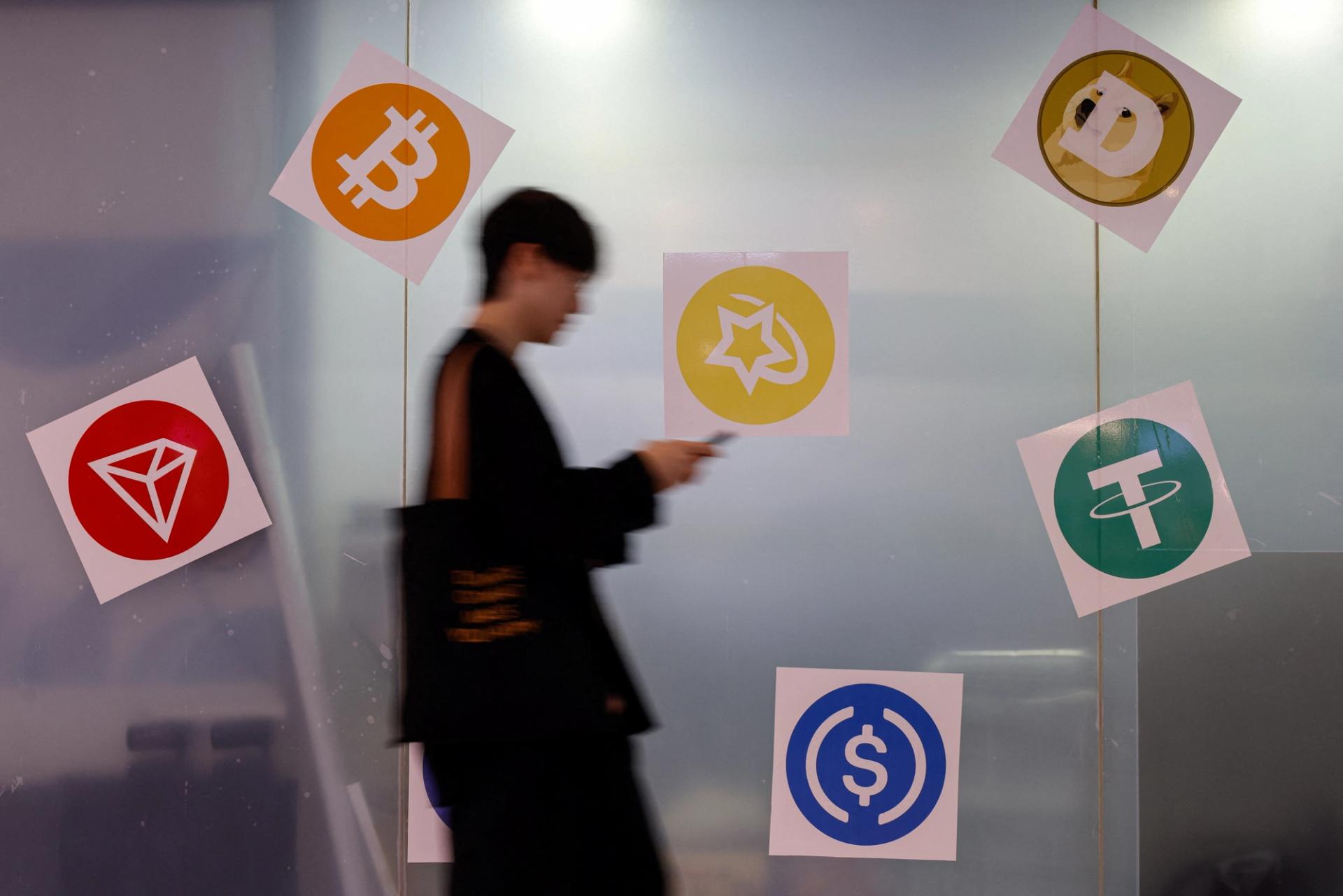 Man walks past cryptocurrency exchange in Hong Kong.