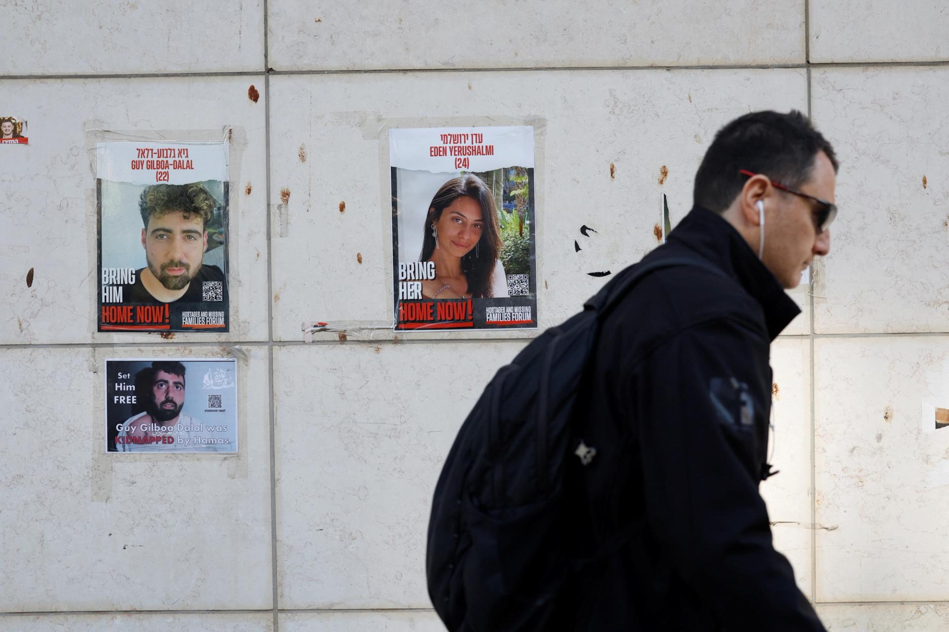A man walks past posters with photos of hostages kidnapped in the deadly October 7 attack on Israel by the Palestinian Islamist group Hamas from Gaza, in Tel Aviv, Israel March 5, 2024. REUTERS/Carlos Garcia Rawlins