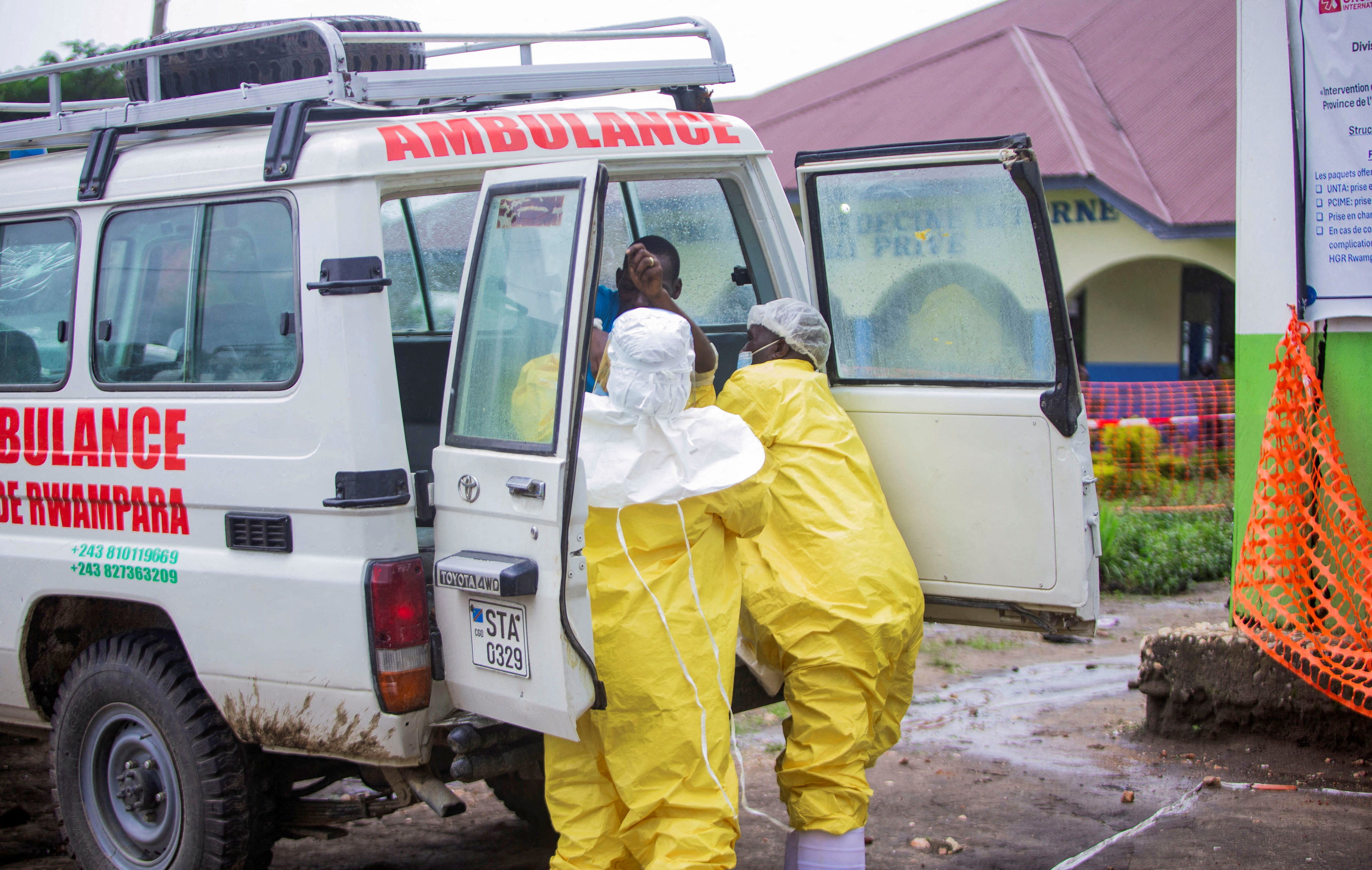 Congolese health workers receive a patient.