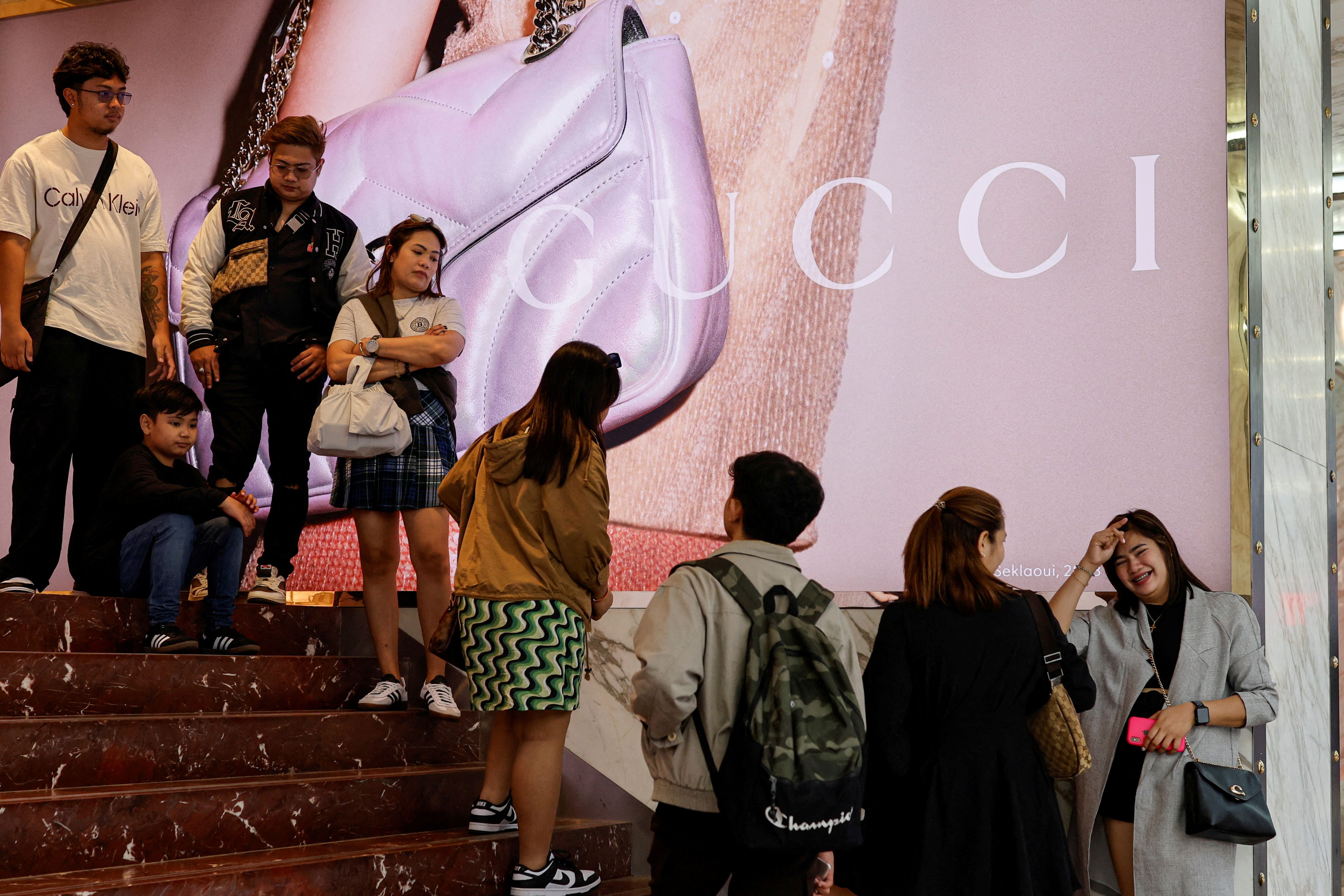 People queue outside a Gucci store in Tsim Sha Tsui.