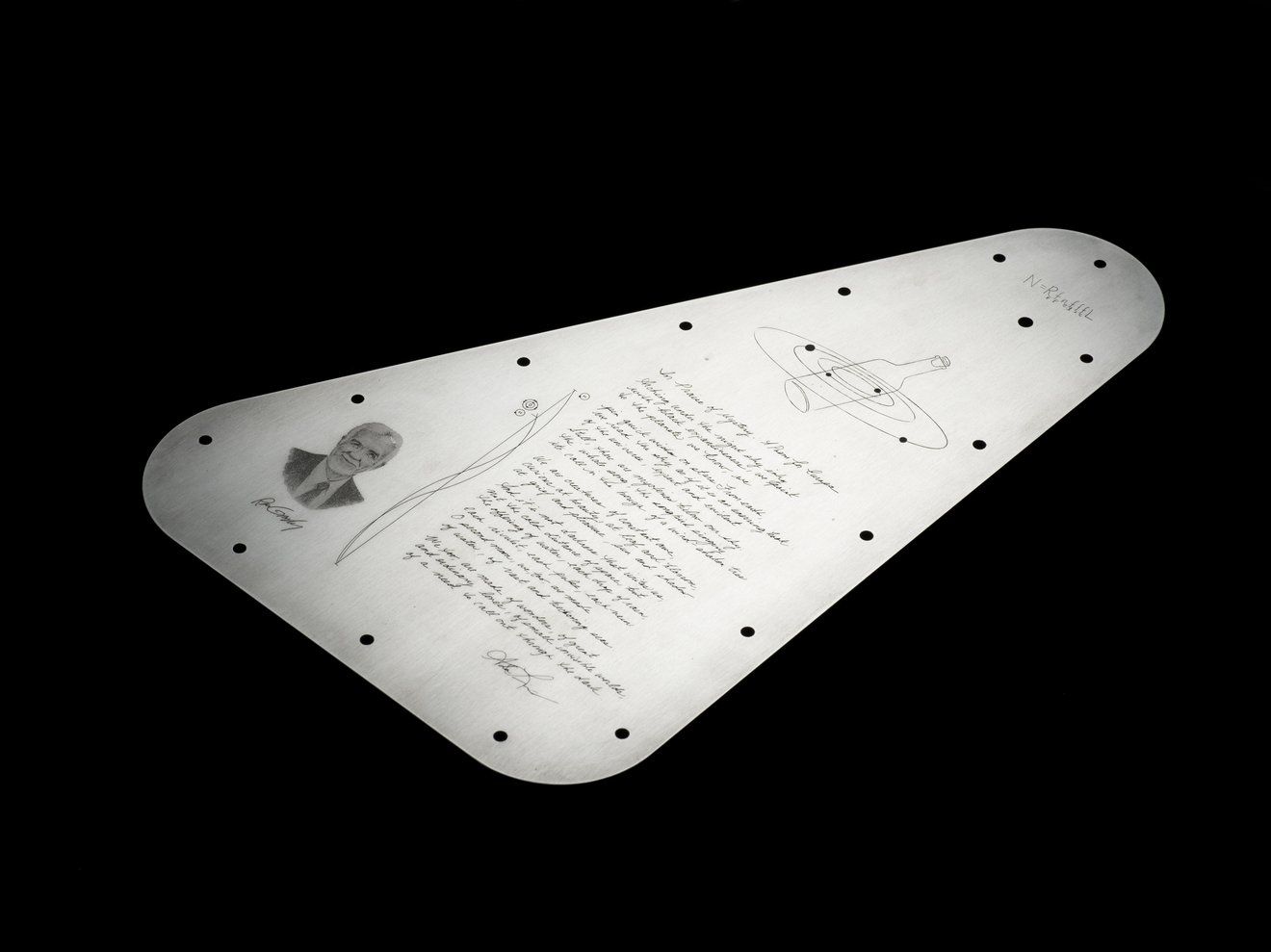 The metal plate with the engraved poem.