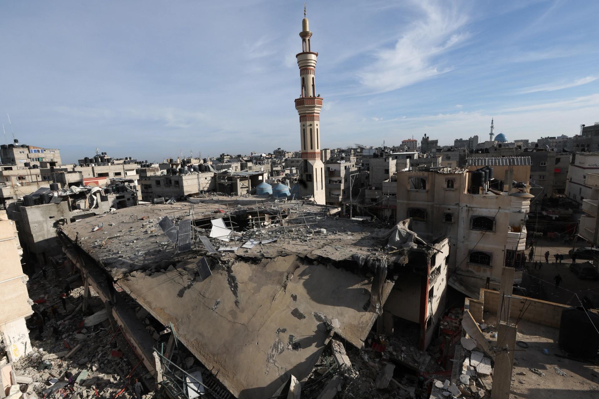 Palestinians inspect the site of an Israeli strike on a mosque, amid the ongoing conflict between Israel and the Palestinian Islamist group Hamas, in Rafah in the southern Gaza Strip