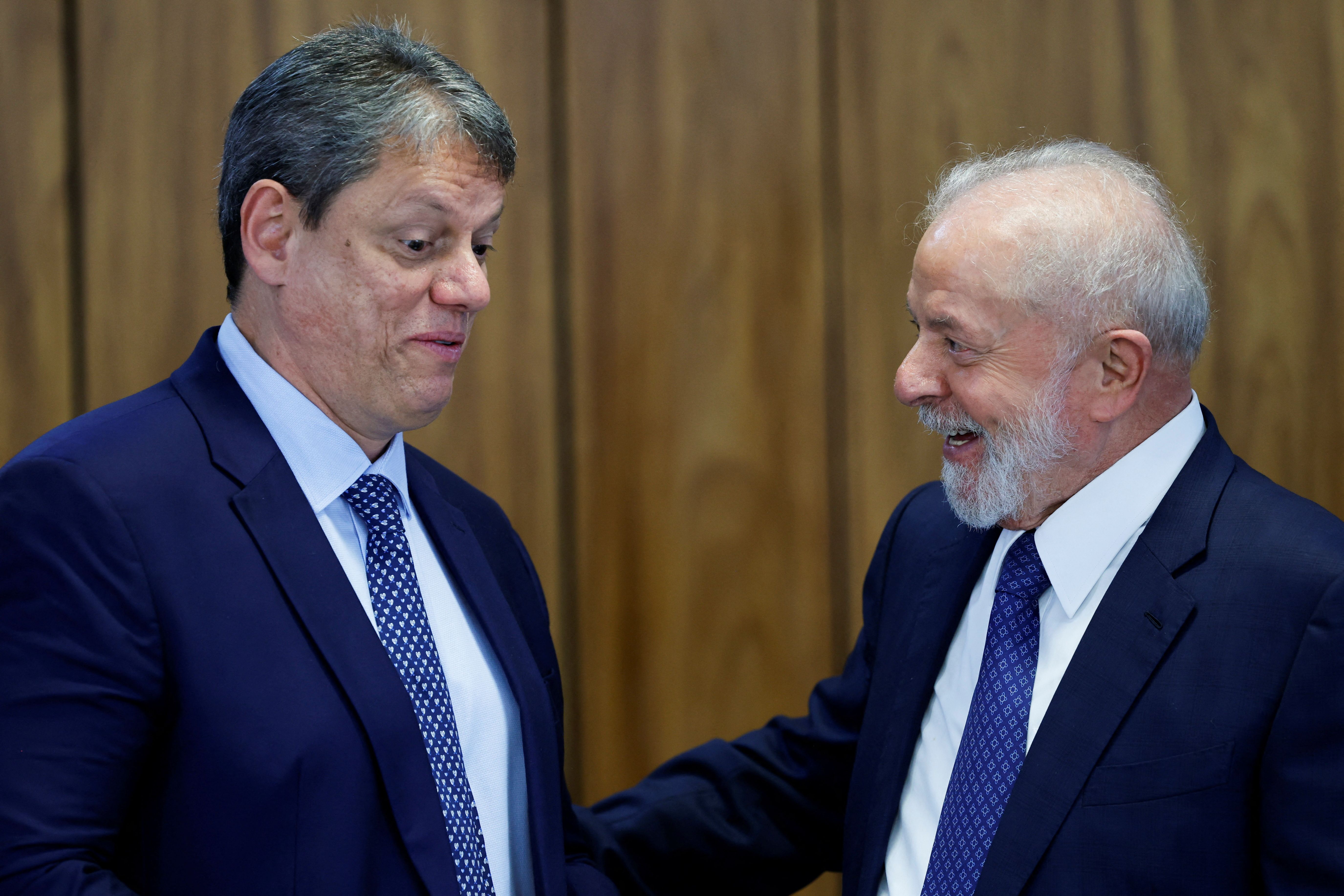 Brazil’s president Luiz Inacio Lula da Silva talks with Sao Paulo’s Governor Tarcisio de Freitas during a ceremony announcing investments by public banks in States, at the Planalto Palace in Brasilia, Brazil, December 12, 2023.