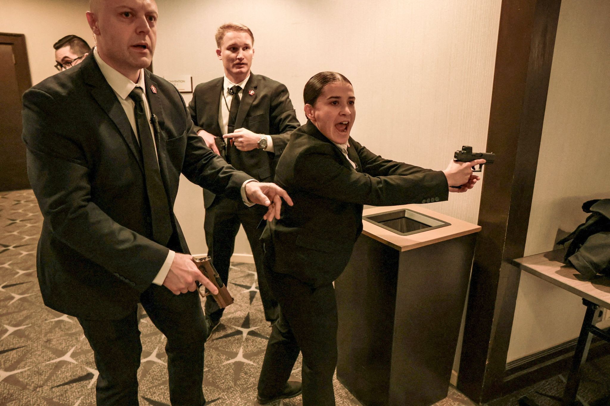 Security officials react as a shooter opens fire during the annual White House Correspondents’ Association dinner in Washington, DC.