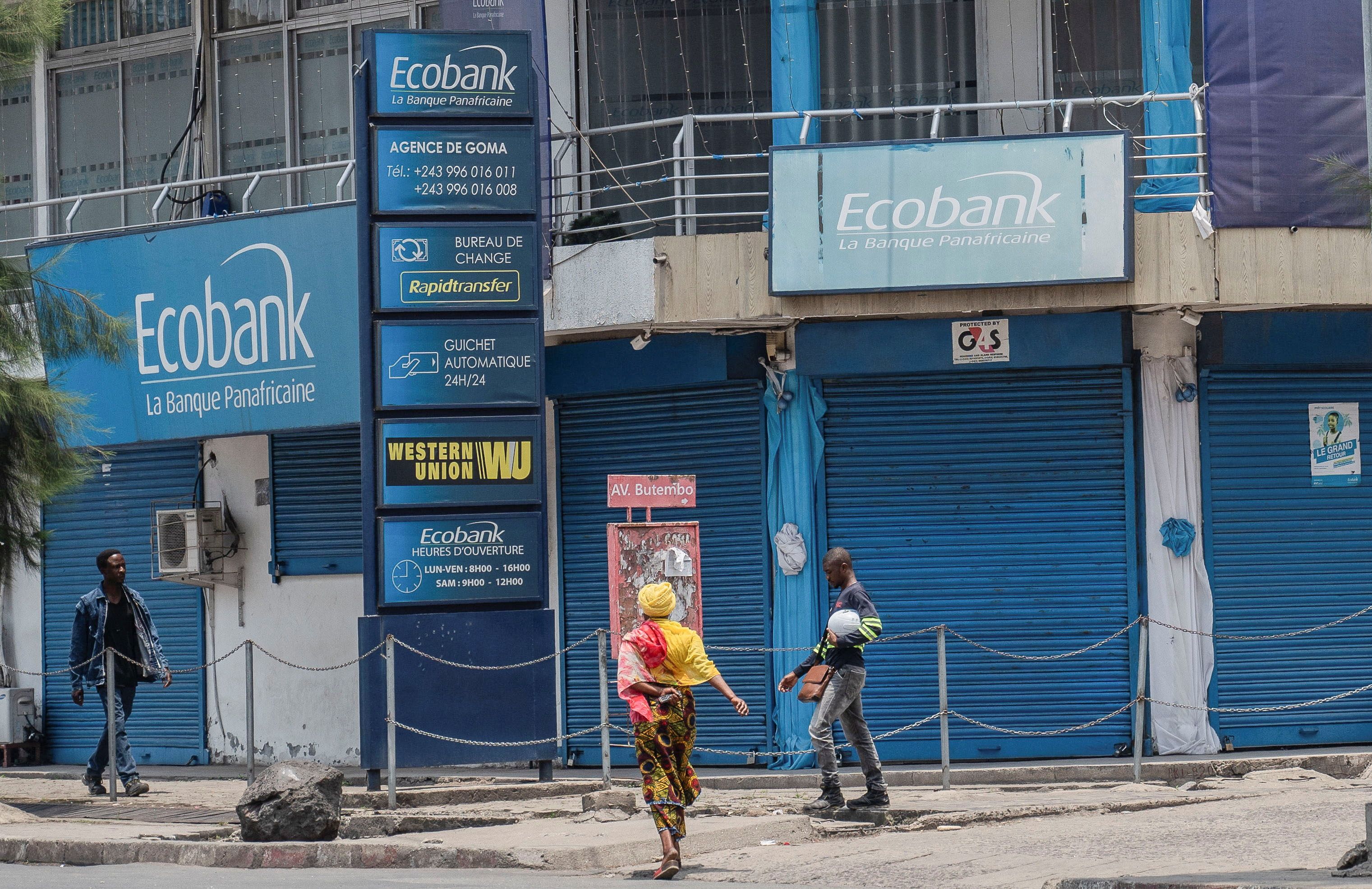 People walk outside the closed Ecobank branch.