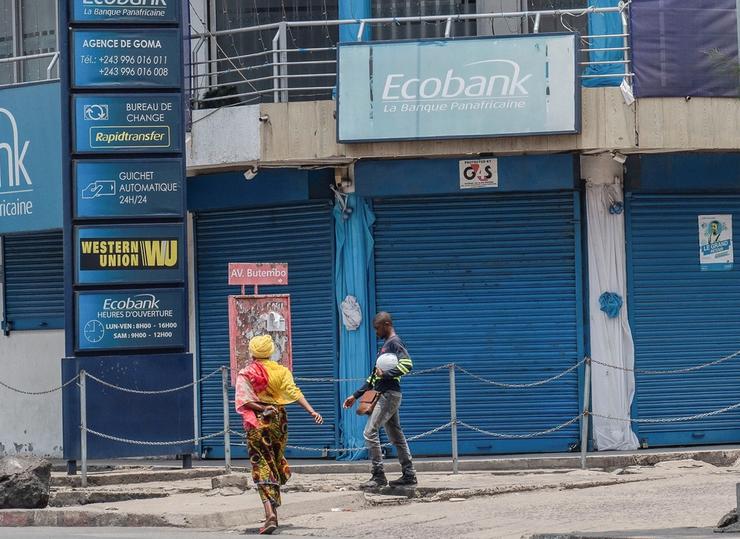 People walk outside the closed Ecobank branch.