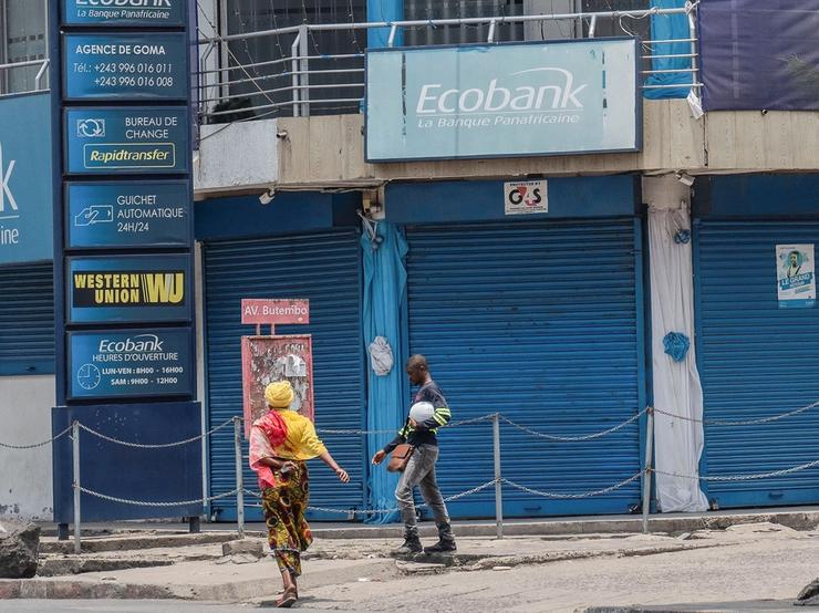 People walk outside the closed Ecobank branch.