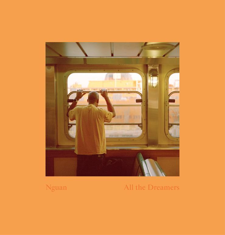 The cover of Nguan’s “All the Dreamers,” showing a man leaning against a window on the Staten Island Ferry.