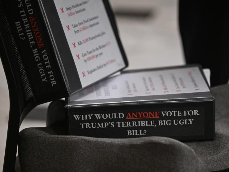 Binders that read: Why would anyone vote for Trump’s terrible, big ugly bill?