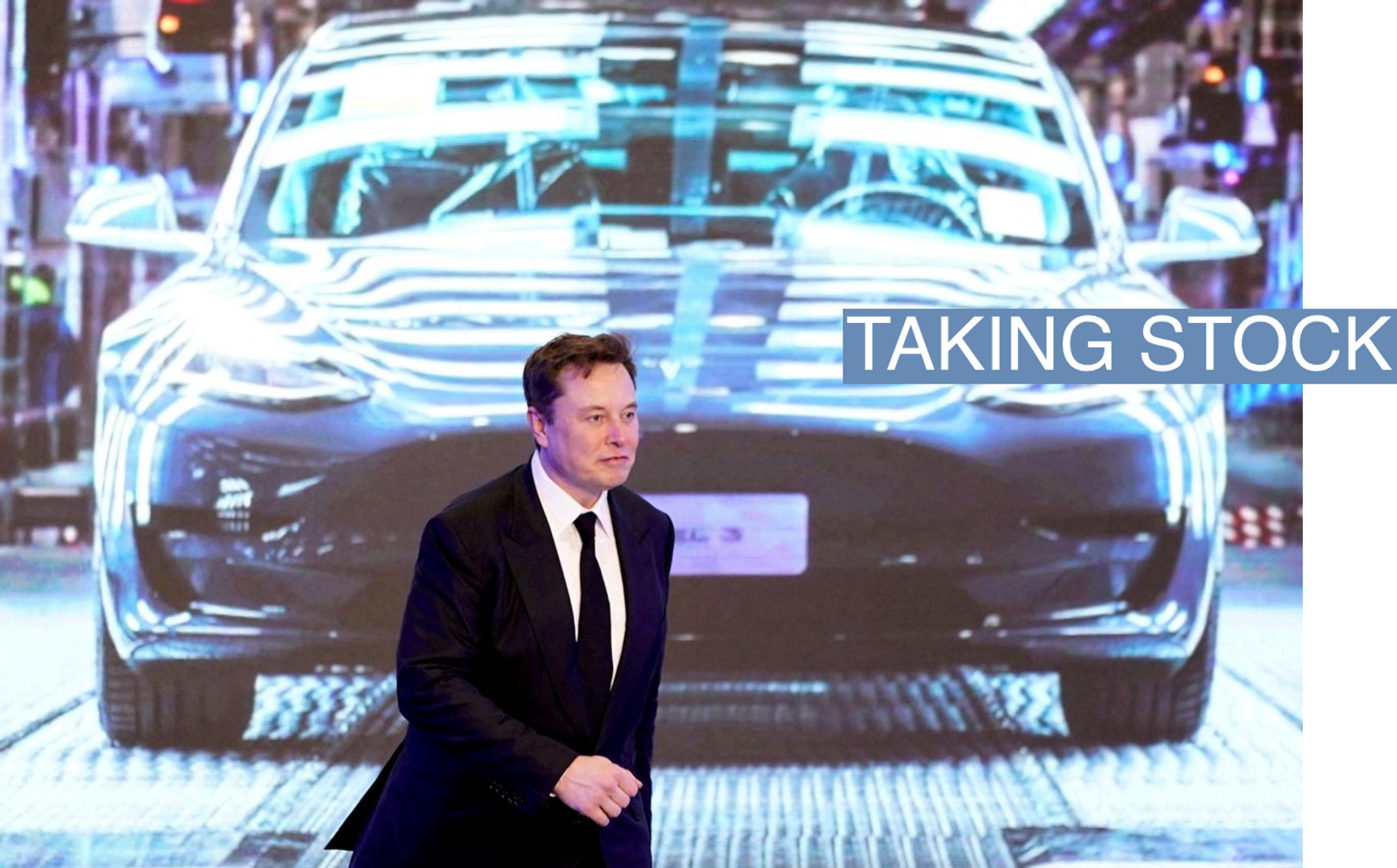 Tesla Inc CEO Elon Musk walks next to a screen showing an image of Tesla Model 3 car during an opening ceremony for Tesla China-made Model Y program in Shanghai, China January 7, 2020. 