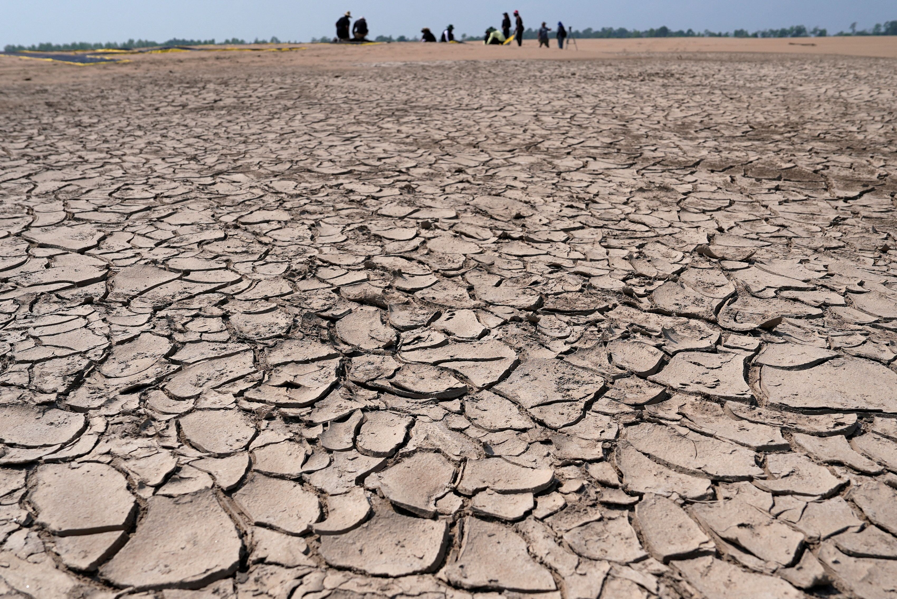 Greenpeace activists prepare a protest message over sandbanks exposed due to drought at the Solimoes River.