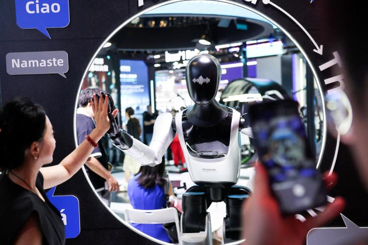 People interact with a robot at the Shanghai Artificial Intelligence conference