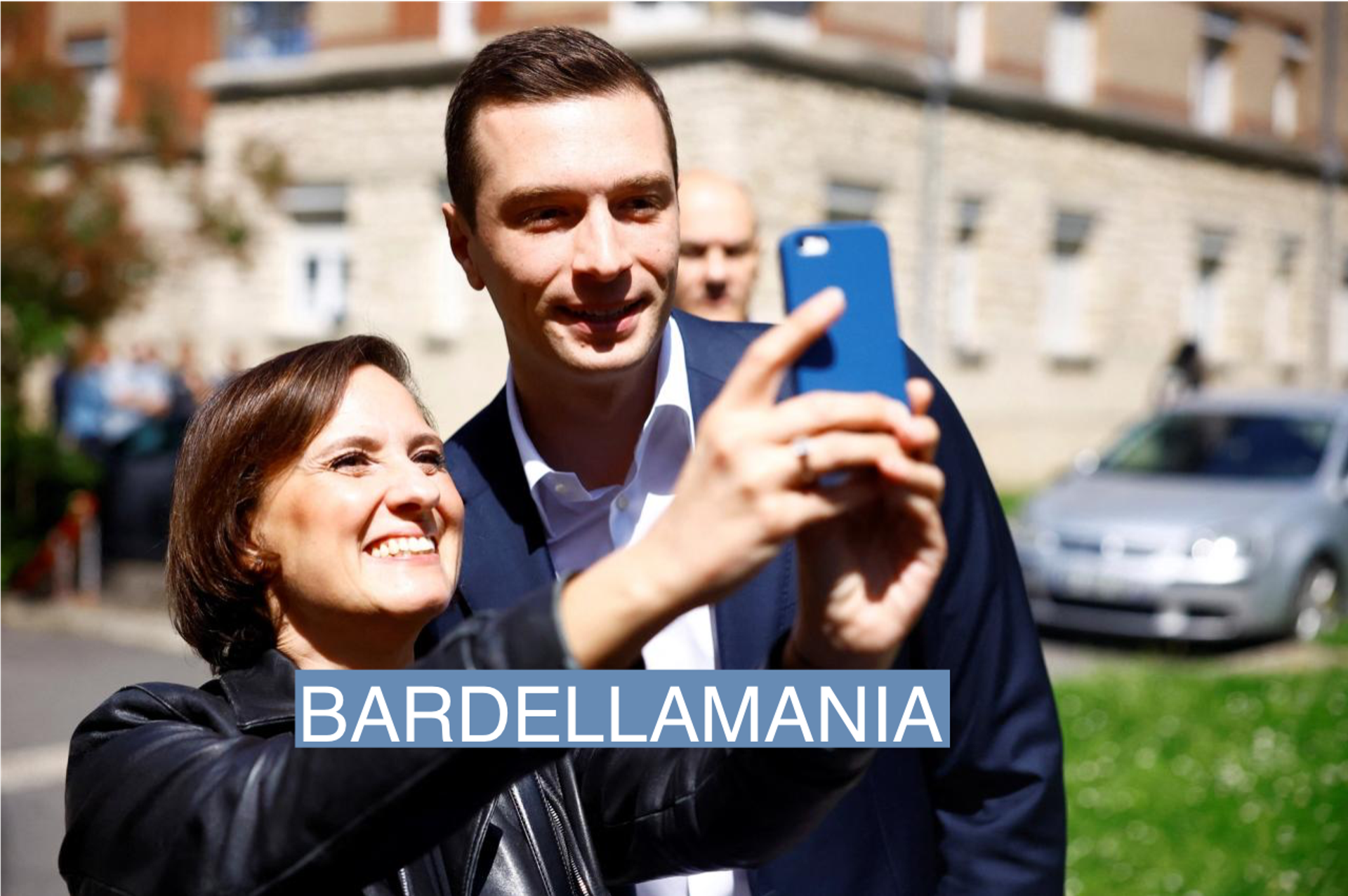 Jordan Bardella taking a selfie with a supporter.