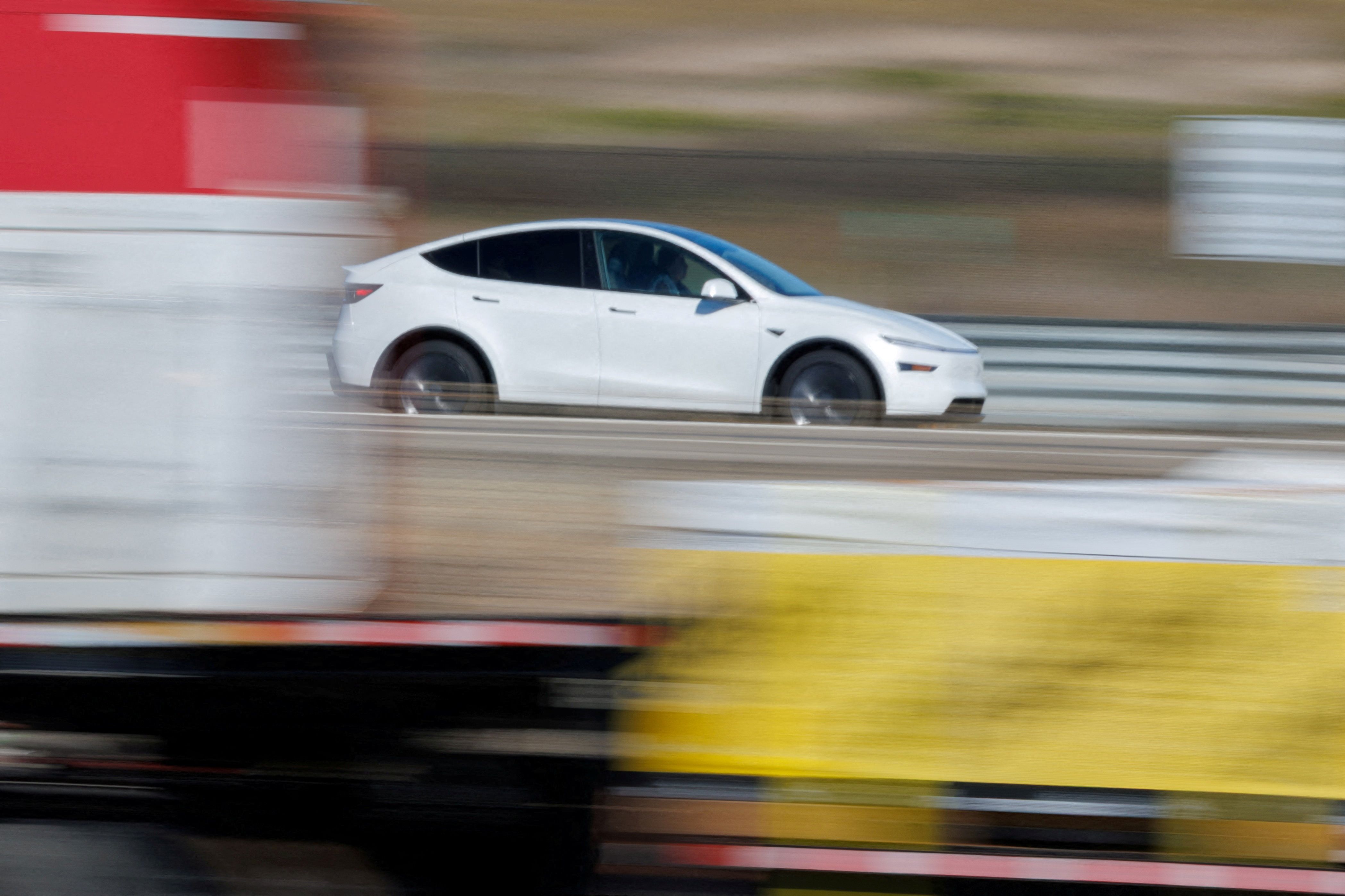 A Tesla Model Y travels down the highway near Oceanside, California.